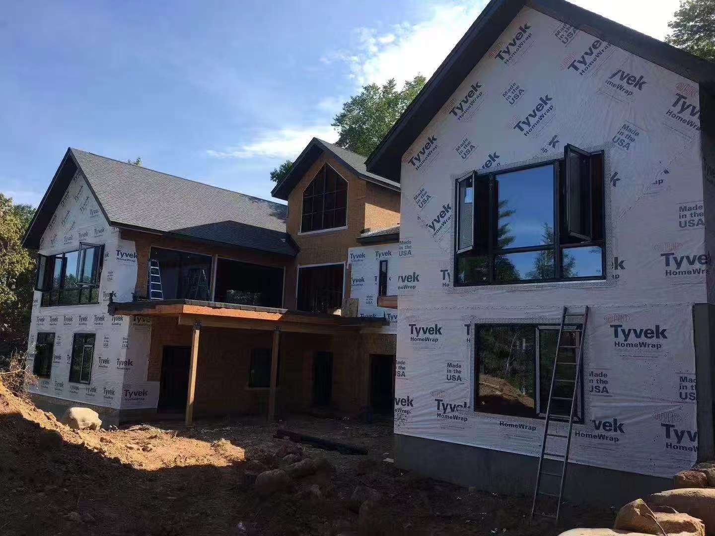 Supplier project photograph showing installed windows in a two-storey house during construction